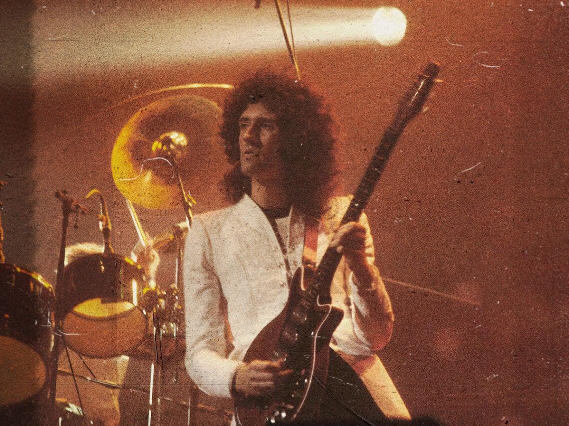 Brian May performing with Queen in 1977