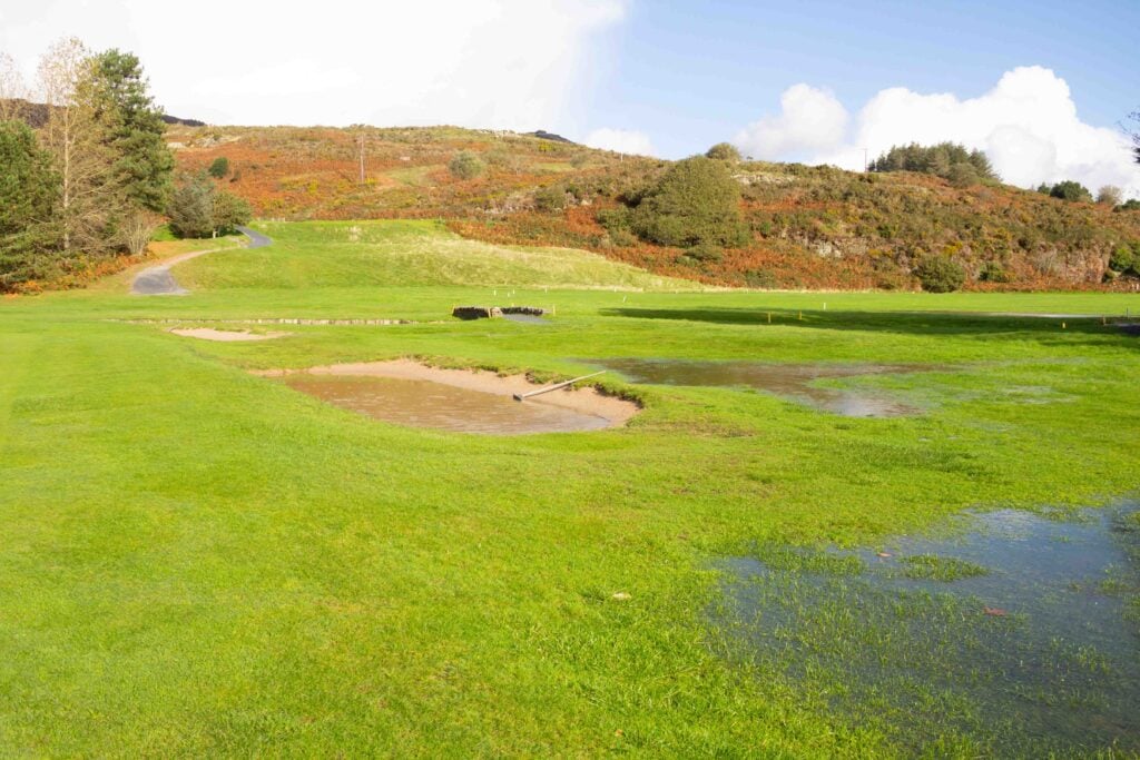 A flooded bunker on a golf course | Source: Adobe Stock