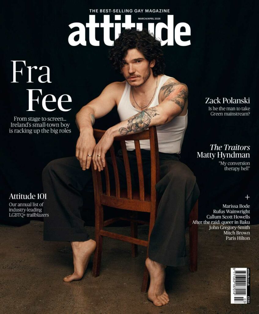 Fra Fee, barefoot and wearing a white vest, sits on a backwards red chair on the cover of Attitude magazine