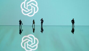 This photograph taken in Mulhouse, eastern France on October 19, 2023, shows figurines next to the ChatGPT logo. (Photo by SEBASTIEN BOZON/AFP via Getty Images)