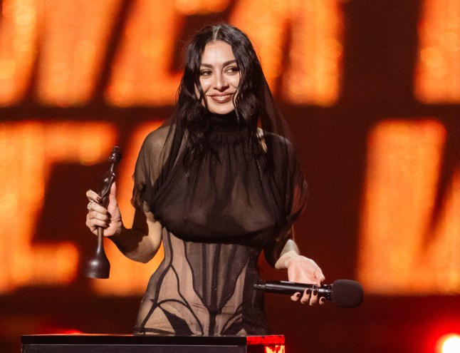 Charli XCX onstage accepting one of her trophies at The BRIT Awards 2025