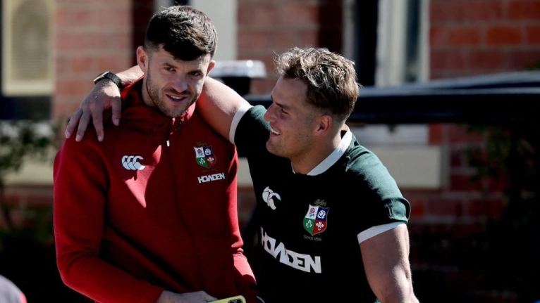 British and Irish Lions' Blair Kinghorn (C) talks to his teammate Duhan Van Der Merwe