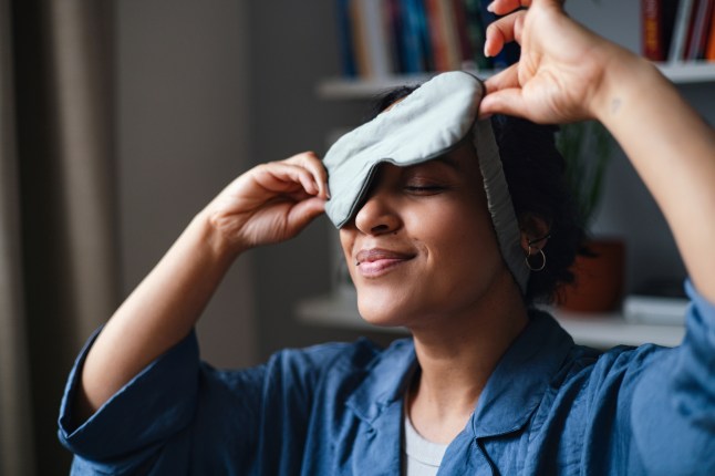 Relaxed Woman Wearing Sleep Mask At Home During Cozy Morning Routine