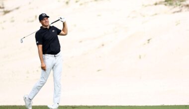 Jordan Spieth walking on a golf course with a club, at the 2025 Hero World Challenge