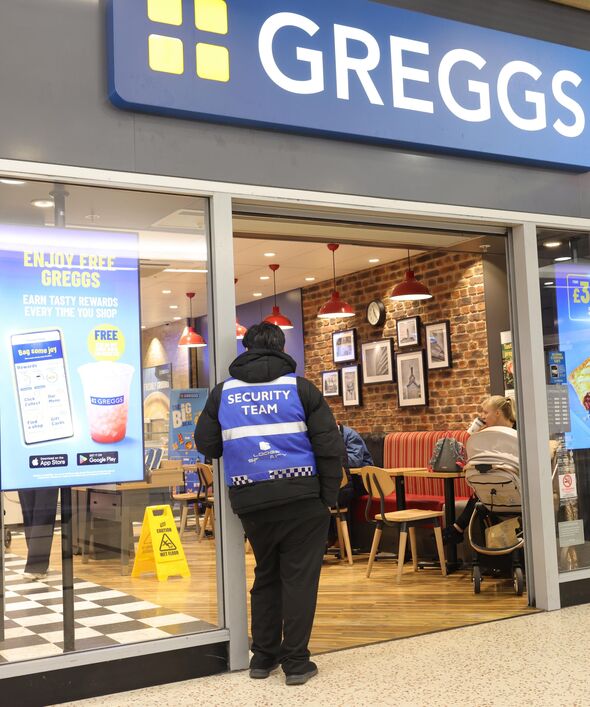 Security guard standing outside Greggs bakery Luton
