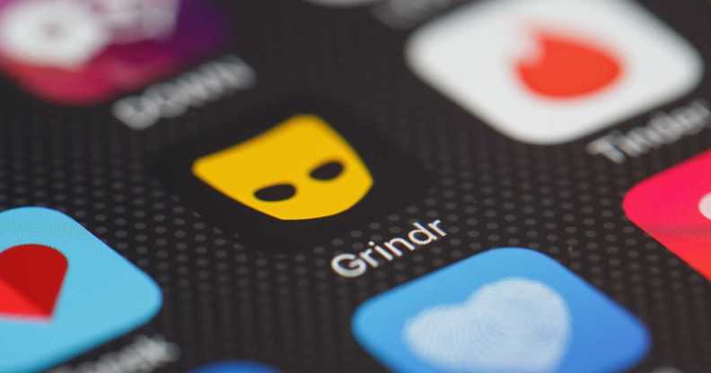 The "Grindr" app logo is seen amongst other dating apps on a mobile phone screen.