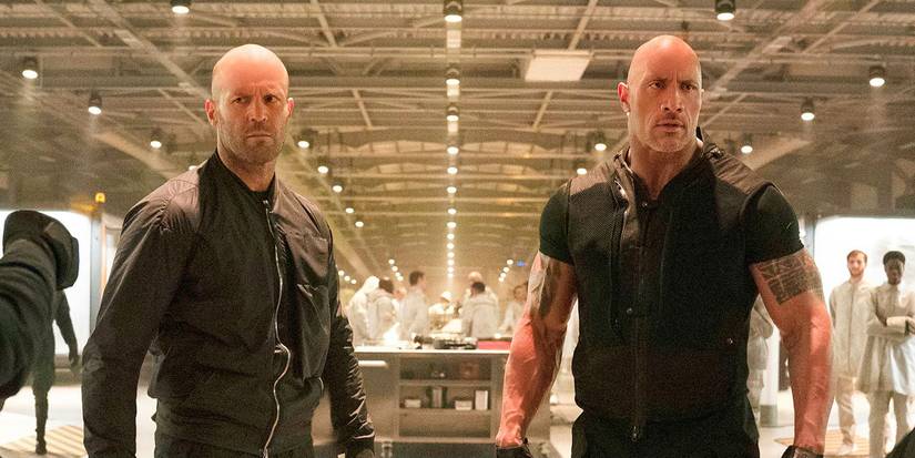 Jason Statham as Deckard Shaw and Dwayne Johnson as Luke Hobbs standing menacingly in Hobbs & Shaw