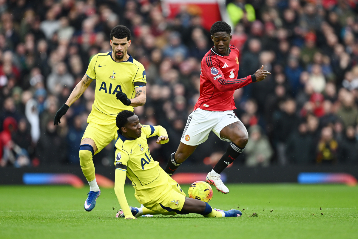 Kobbie Mainoo jumps over a challenge from Pape Matar Sarr of Tottenham.