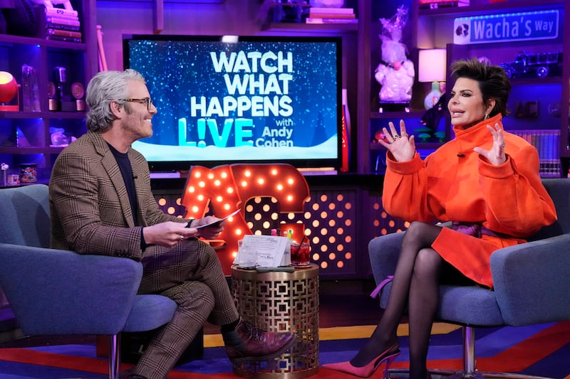 A demonstrative Lisa Rinna sits opposite Andy Cohen while being interviewed in the Bravo Clubhouse.