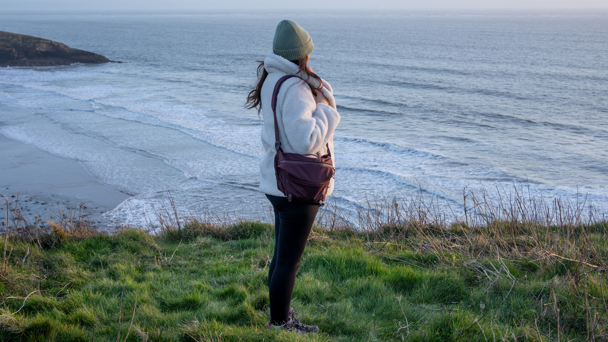 The PD sling bag 7L in use, around the author's shoulder, who is looking out to sea.