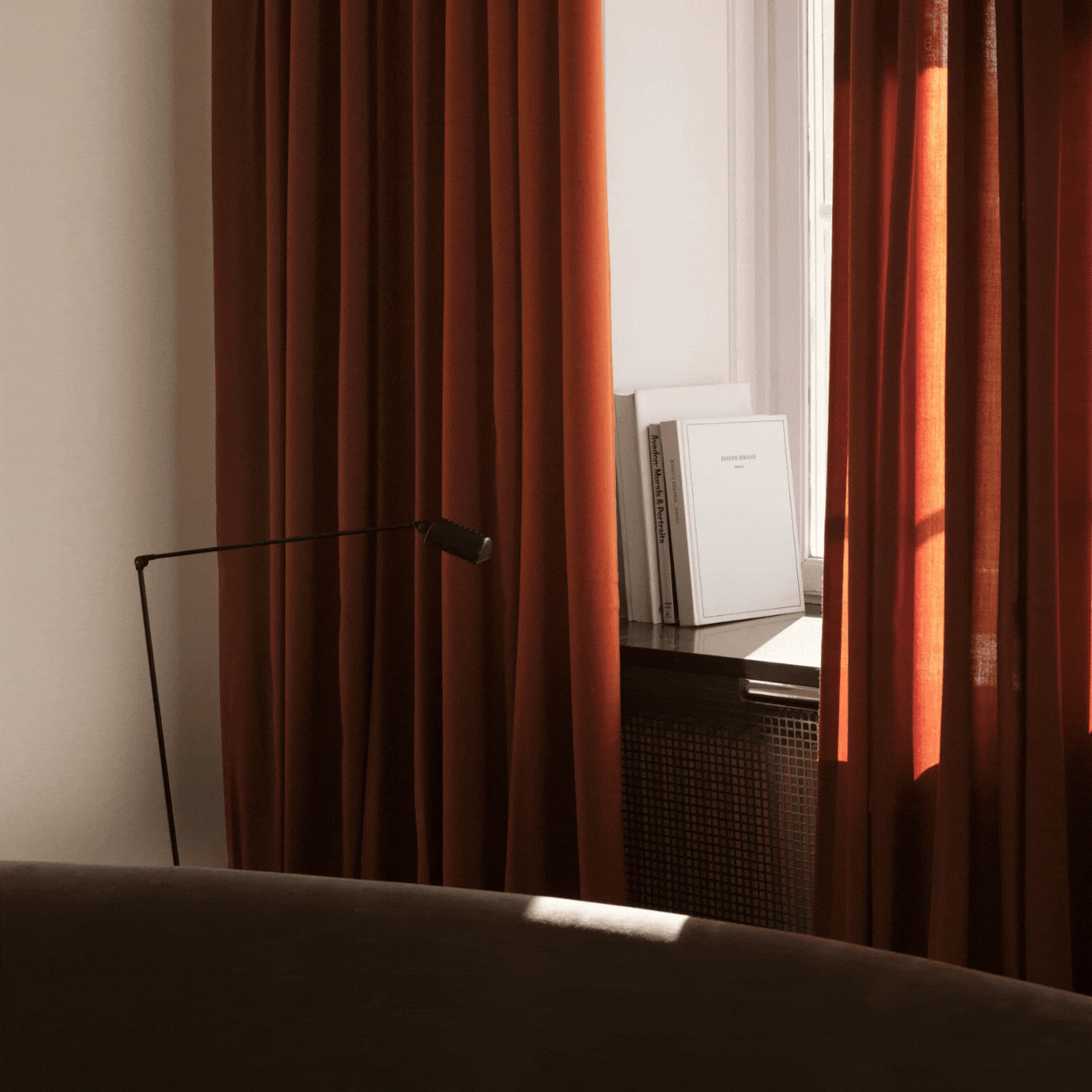 A rotating gif showcasing burnt red curtains as styled in a naturally lit living room and up close as a detail.