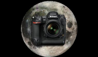 A Nikon DSLR camera is centered in front of a large, detailed image of the full moon, both set against a black background.