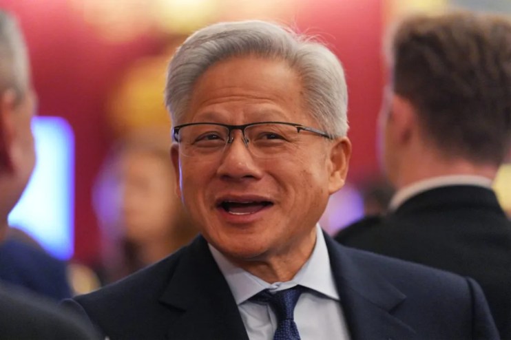 Nvidia CEO Jensen Huang speaking at a tech conference, emphasizing AI advancements and industry innovation.