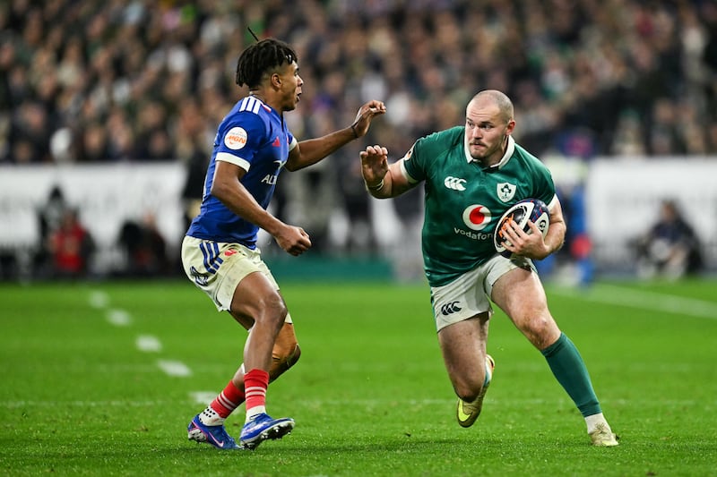 Ireland's Jacob Stockdale challenges France's Théo Attissogbe. Photograph: Julie Sebadelha/AFP via Getty Images