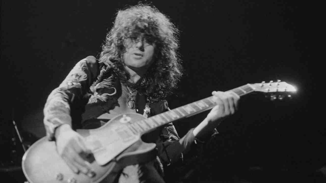Jimmy Page performing onstage in the 1970s