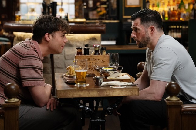 Lewis talks to Ross in the pub in Emmerdale