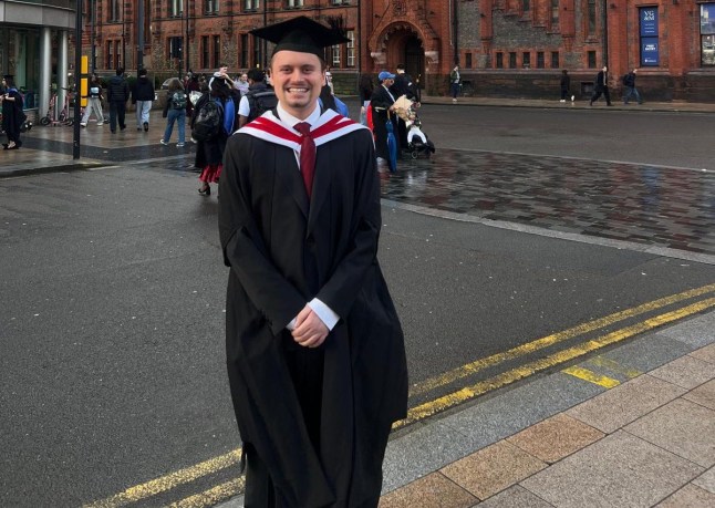 Alex Warwick standing outside in a city in a graduation cap and gown, smiling at the camera (Picture: Alex Warwick)