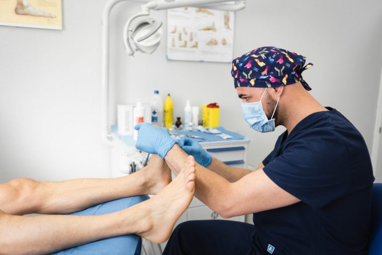 A podiatrist attends to a client's feet