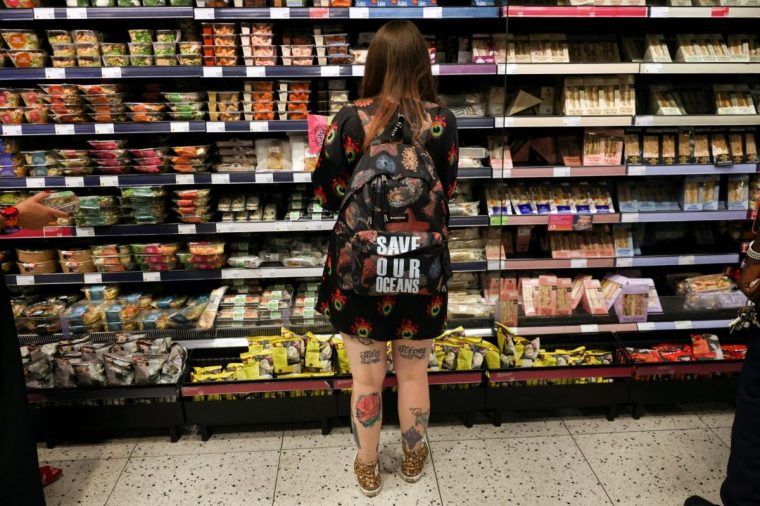 A shopper examines food items in London as US tariffs risk pushing UK prices (Photo: Kevin Coombs/Reuters)