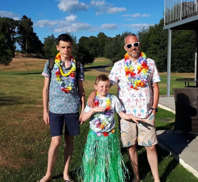 Robert Cochran, 57, is a pensions expert at Scottish Widows. Robert with his sons at a Hawaiian themed party (Photo: supplied by Robert Cochran)