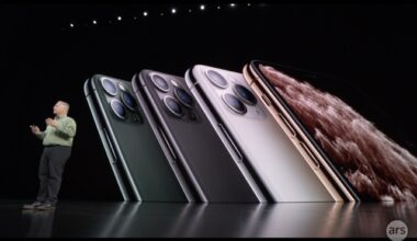 A man on a stage in front of a huge video display.