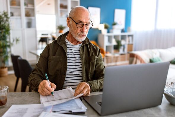Senior man typing on computer, planning finances