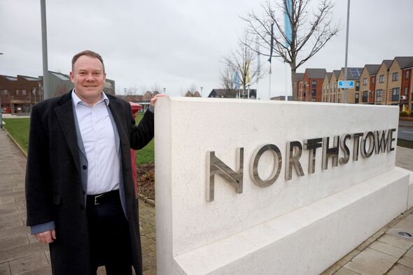 Tom Bygott next to a Northstowe sign