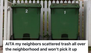 Two trash bins beside a white picket fence