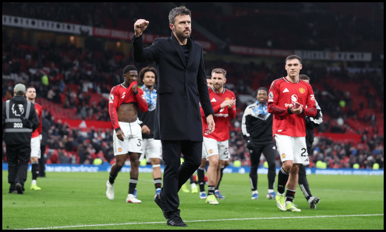Michael Carrick gestures to the Man United fans as he exits the pitch after a win.