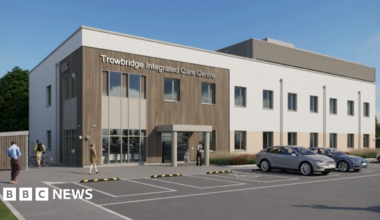 A mock-up of a building which says 'Trowbridge Integrated Care Centre' and has cars parked outside.