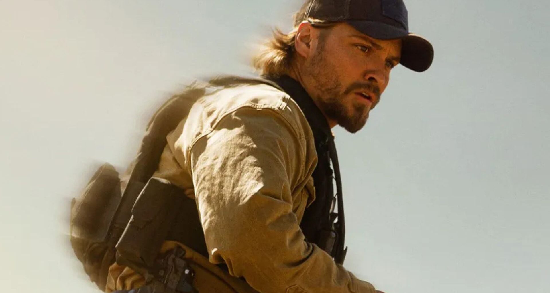 Luke Grimes looks at something off-screen