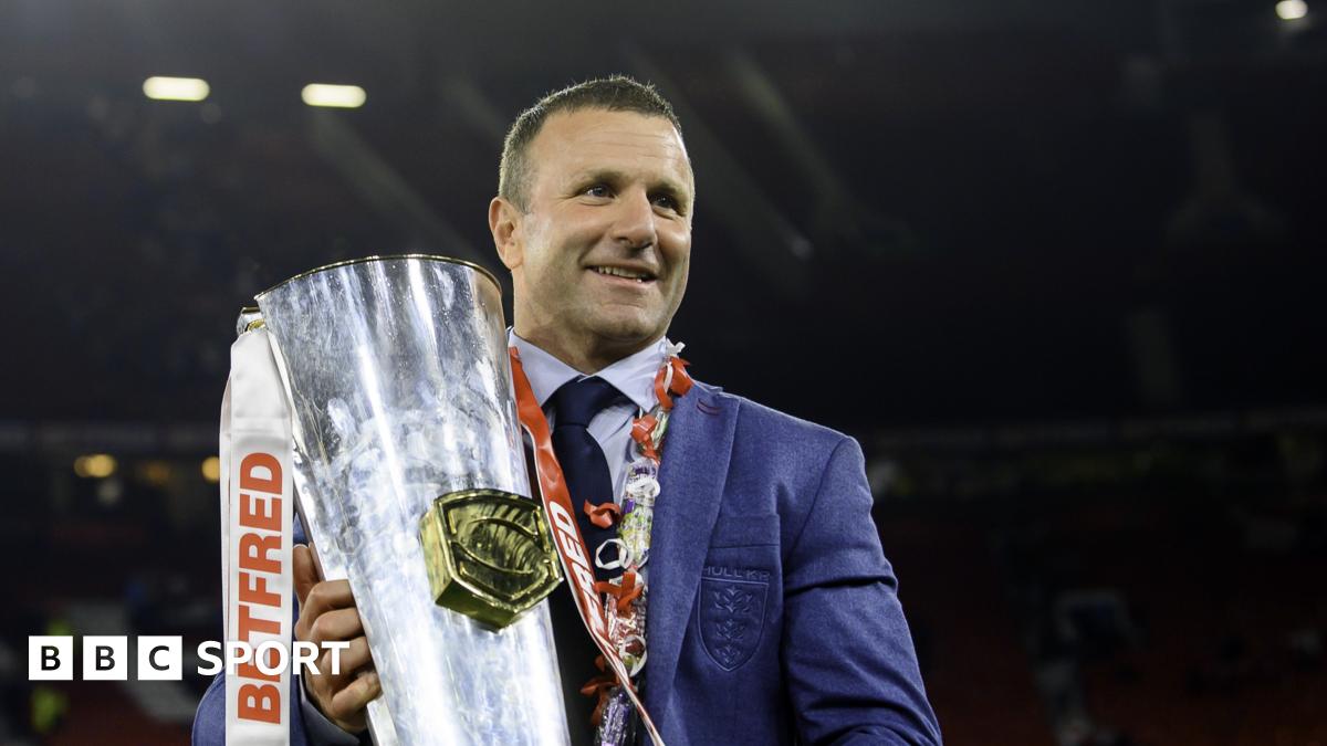 Willie Peters holds a rugby ball, with an Australia player in the background