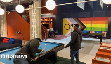 A smiling Charlie MacGregor has short fair hair and a close-clipped bear. He is wearing a white open-necked shirt