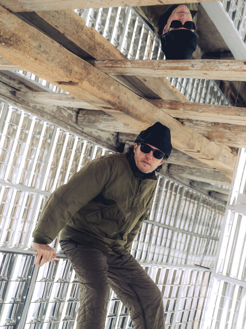 alexandre de betak inserts reflective light installation into traditional swiss barn