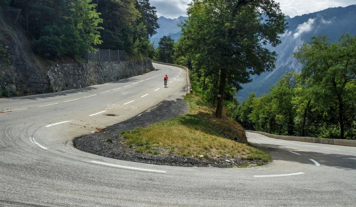 L'Alpe d'Huez, France - August 19, 2019: Ascent of the famous climb to L'Alpe d'Huez and itinerary of the Tour de France at bend 21.