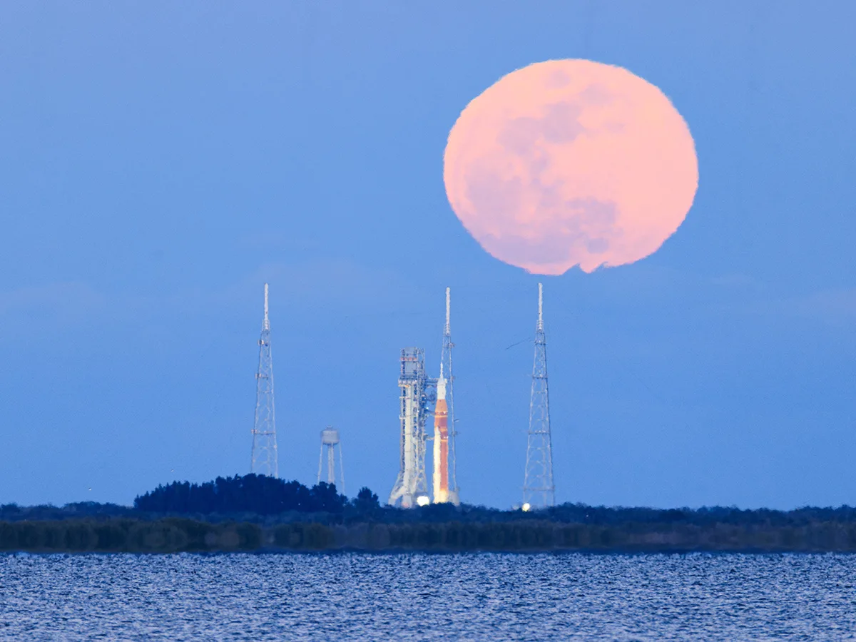 The 1 February 2026 full Moon above the Artemis II Space Launch System, Kennedy Space Center, Florida, USA, 1 February 2026, 18:04 EST. Captured by Chengcheng Xu, Tianyao Yang. Equipment: Canon EOS R5 Mark II camera, Canon RF 200–800mm lens. Exposure: ISO 500, f/9, 1/40s