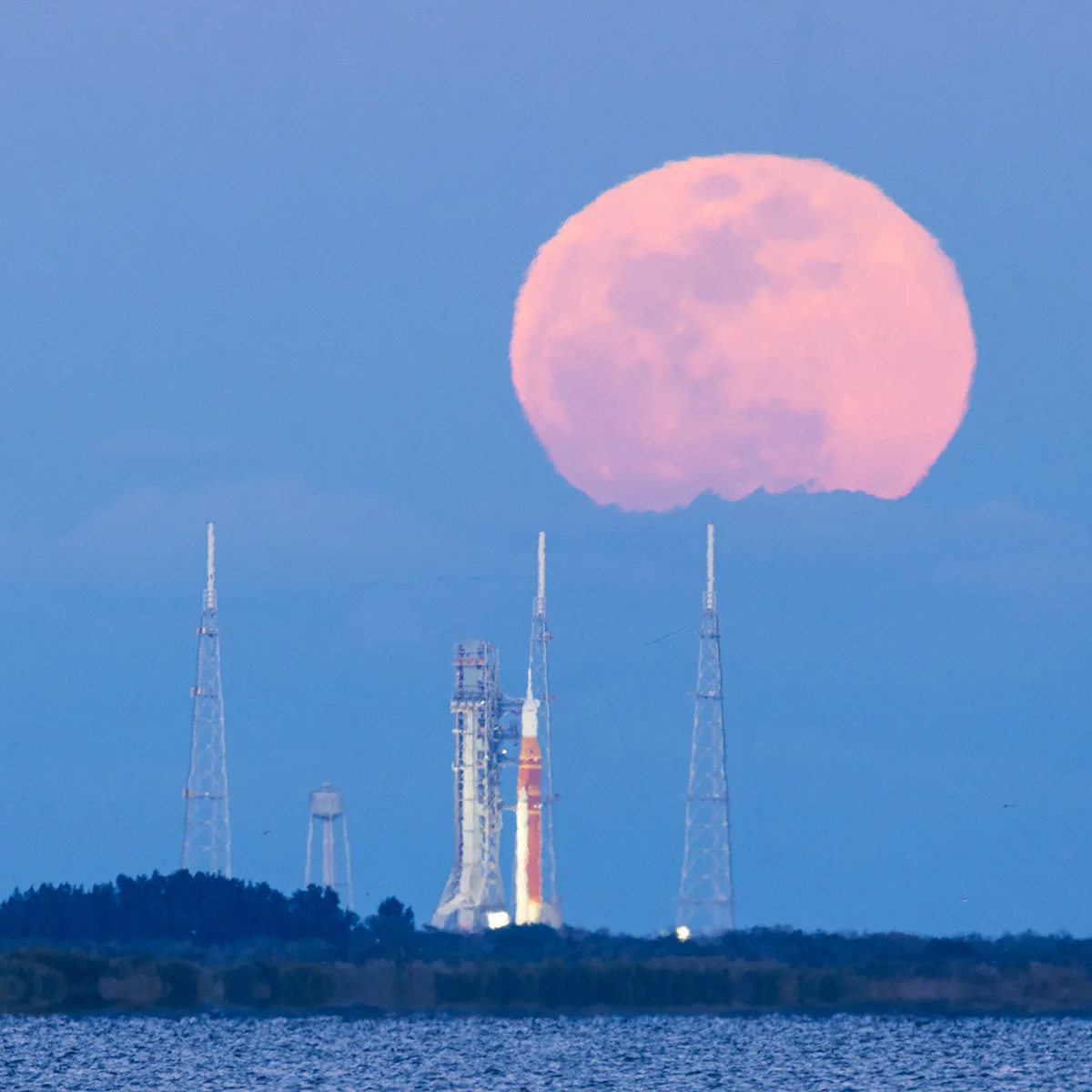 The 1 February 2026 full Moon above the Artemis II Space Launch System, Kennedy Space Center, Florida, USA, 1 February 2026, 18:04 EST. Captured by Chengcheng Xu, Tianyao Yang. Equipment: Canon EOS R5 Mark II camera, Canon RF 200–800mm lens. Exposure: ISO 500, f/9, 1/40s