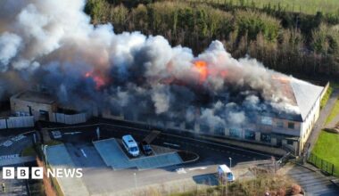 Plumes of smoke and flames pour into the sky at a school site in Devon.
