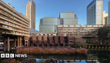 The general area of the brutalist Barbican with an image of the proposed tower blocks in the background superimposed on to the scene
