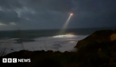 A helicopter with a strong search line flies over Newqyay