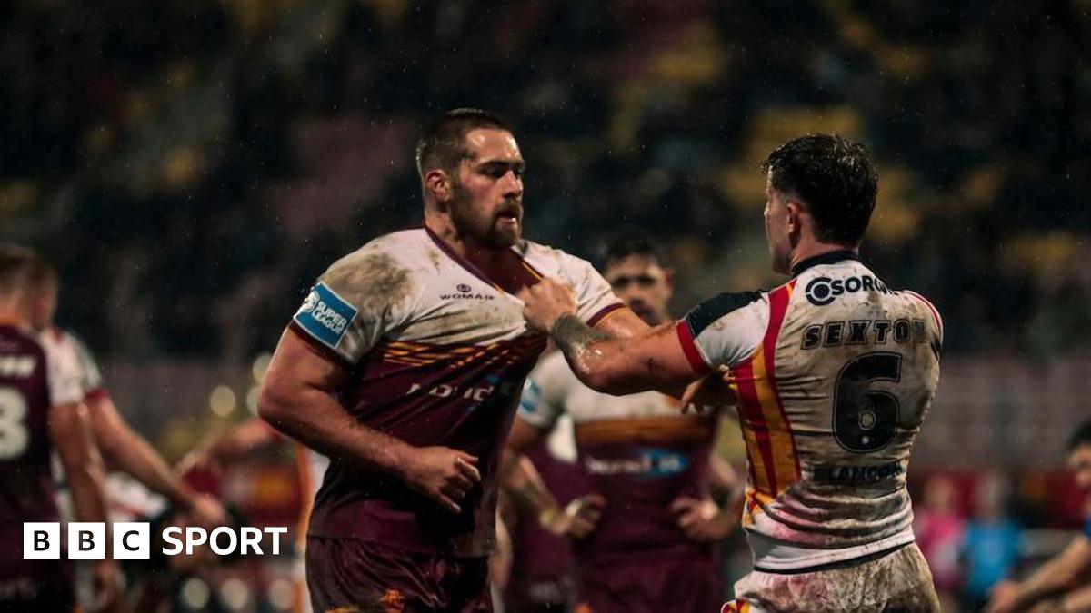 Huddersfield's Sam Hewitt and Catalans' Toby Sexton confront each other, grabbing shirt collars