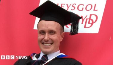 Marcie Niland-Sinyard, 19, smiles at the camera. She is stood outside the Cardiff university.