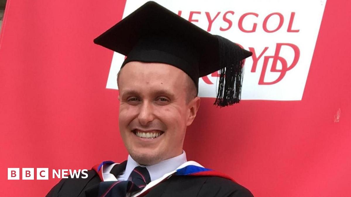 Marcie Niland-Sinyard, 19, smiles at the camera. She is stood outside the Cardiff university.