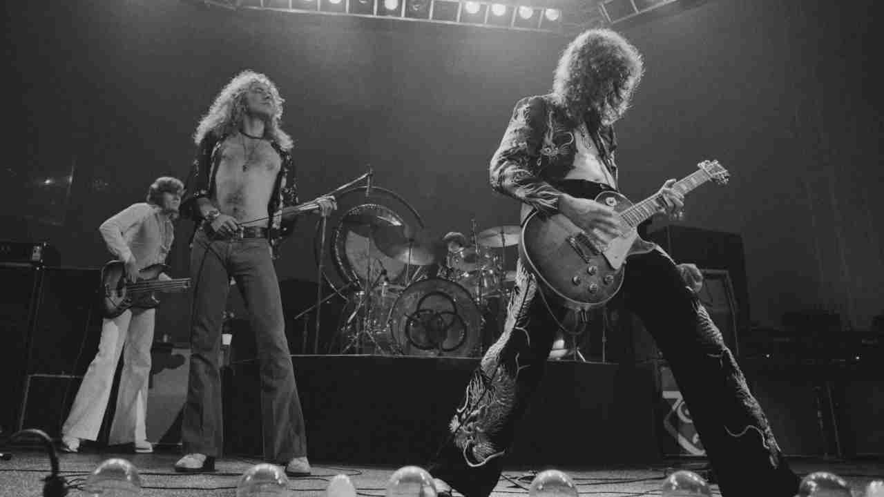 Led Zeppelin performing onstage in 1975