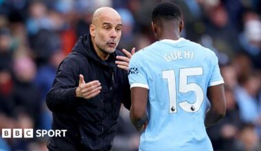 Pep Guardiola, manager of Manchester City, speaks with Marc Guehi on the touchline