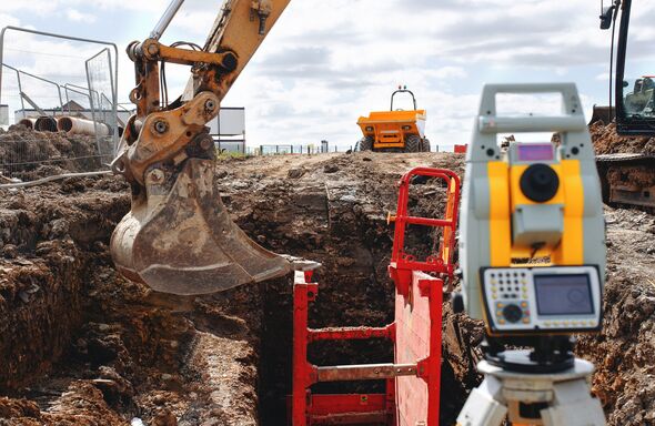 Close-up of Construction survey equipment otal station in use at a building site set by site engineer Close-up of Construction survey equipment otal station in use at a building site set by site engineer