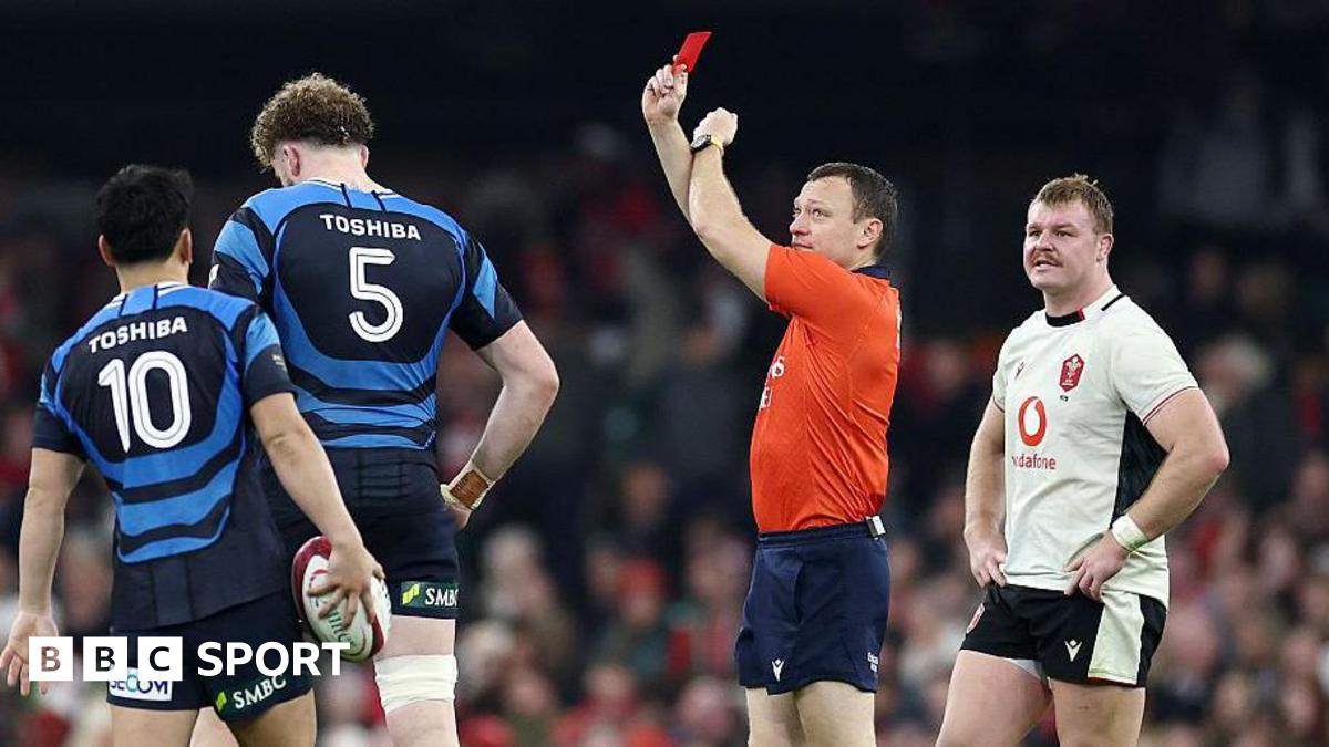 Referee Matthew Carley shows a red card against Wales