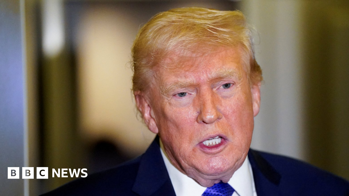 Headshot of US President Donald Trump, wearing a navy coat, white shirt and a royal blue tie