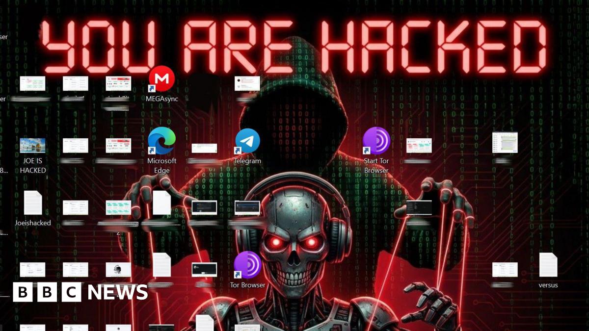 BBC reporter's laptop wallpaper reads "you are hacked" with an image of a robot skull