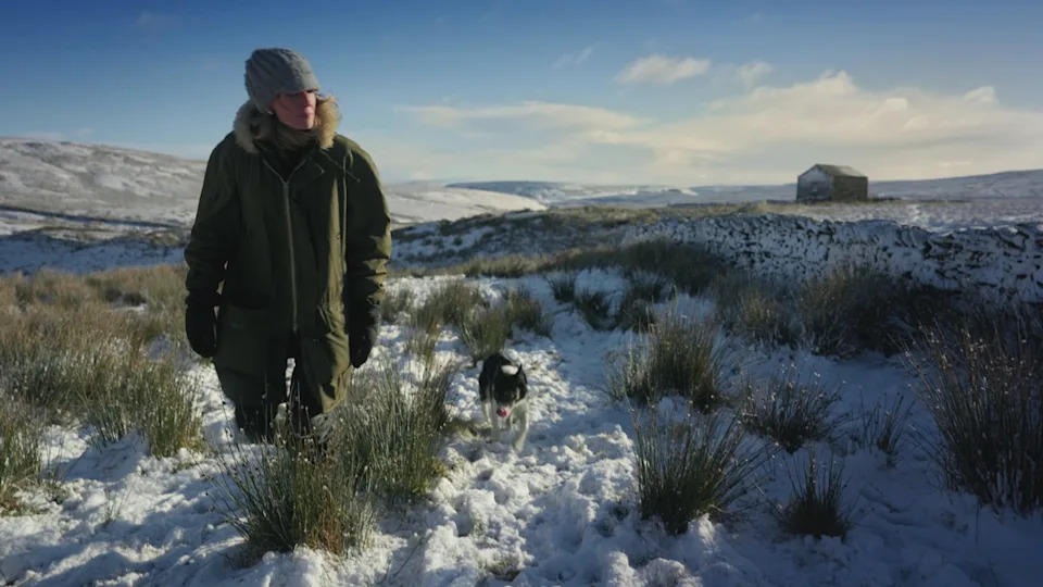Amanda and her sheepdog in the snow near Ravenseat.